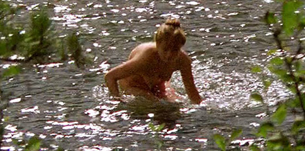 Naked woman urinates directly into the river