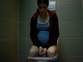 Pregnant schoolgirl pissing in the toilet