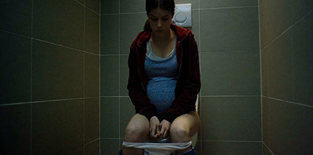Pregnant schoolgirl pissing in the toilet