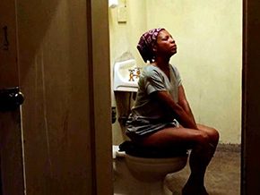 Ebony woman pissing in the prison toilet