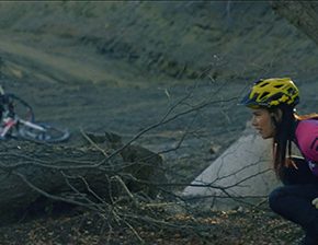 Cyclist urinates in the woods