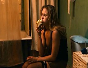 Woman eats banana while urinating