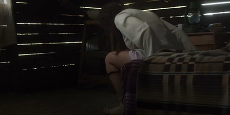 Young woman pissing near the bed